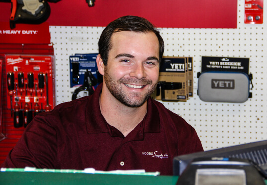 Moore Supply Co employee smiling in a store
