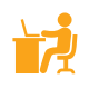 Icon depicting a person sitting at a desk using a laptop