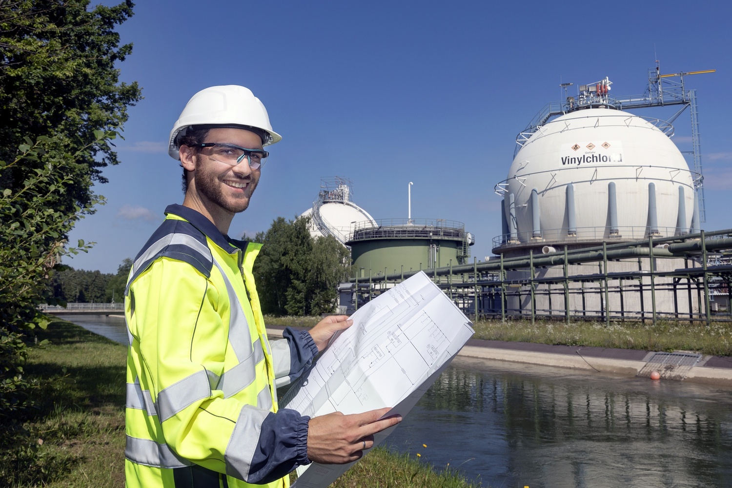 A male engineer is observing the drawings and construction.