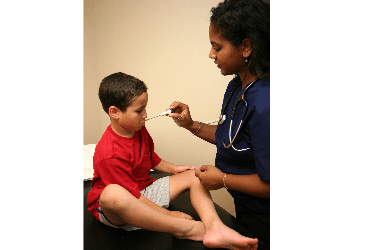 Nurse checks boy's temperature
